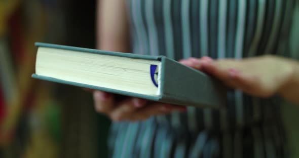 Close View of Opening the Book By Female Hands alt