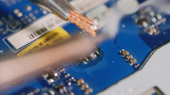 Repairman is Soldering Microchip Cleaning and Removing Residues After It