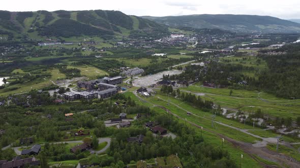 Geilo in Hallingdal Norway - Aerial summer overview showing vacation homes and hotels with green gra alt