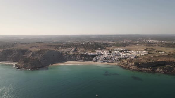 High aerial of Burgau beach in Algarve, Portugal alt