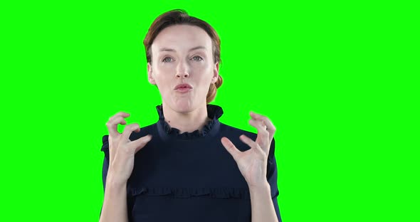 Angry Caucasian woman calling out on green background