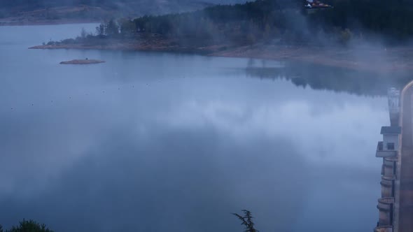 Morning Fog over Dam on Embalse de Aguilar de Campoo, Spain. alt