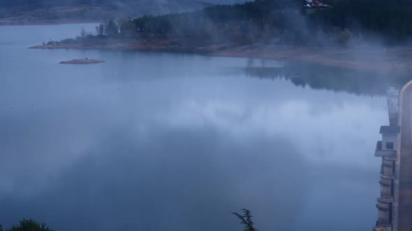 Morning Fog over Dam on Embalse de Aguilar de Campoo, Spain.