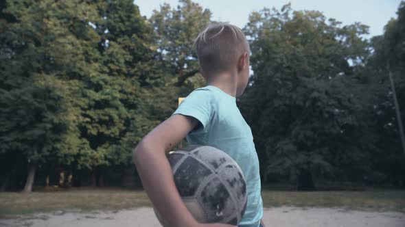 Lonely Upset Boy Holding Football at Pitch, Lack of Friends, Bullying Problem