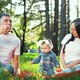 Happy Family with baby Girl Spending Time in Summer Park Blowing Soap Bubbles - VideoHive Item for Sale