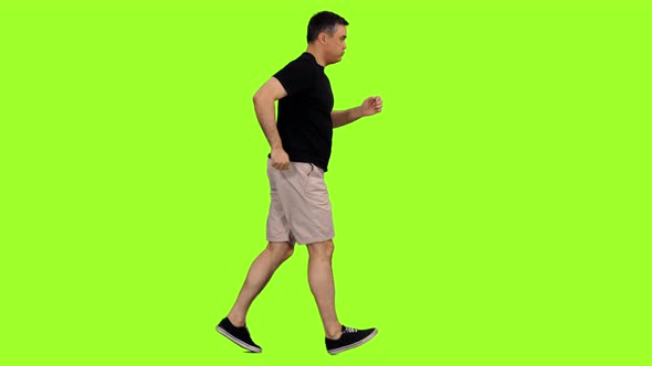 Adult Man Jogging in Shorts and Black T-shirt