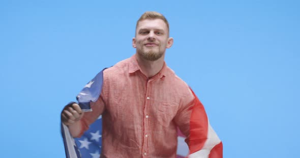 Young Man Dancing and Holding US Flag alt