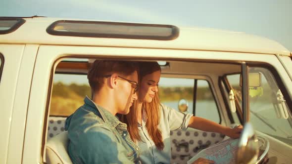 Couple Travel With Map In Car In Summer. Happy Smiling Young People alt