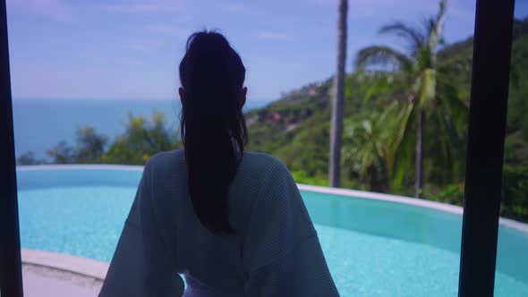 Pretty Girl In Swimming Suit In Luxurious Villa Walking Towards Infinity Pool