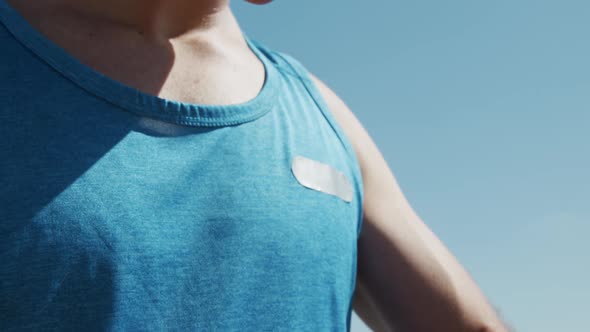 Close up view of male rower looking at his watch alt