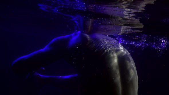 Naked Muscular Man Is Moving in Pool, Underwater Shot, Brawny Back and Arms alt