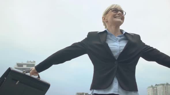 Cheerful Businesswoman Spinning and Making Winner Gesture, Successful Deal