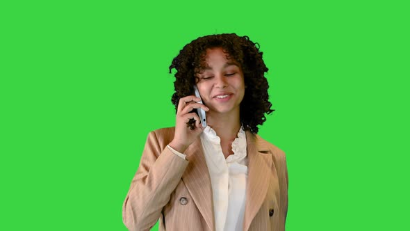 American Woman Making a Phone Call While Walking on a Green Screen, Chroma Key. alt