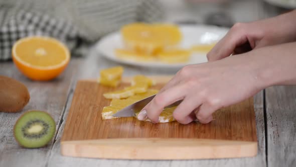 Closeup of Cut Orange Fruit on Wooden Cutting Board