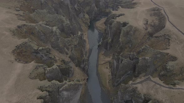 Aerial top-down forward over magnificent and massive Fjadrargljufur canyon, Iceland alt