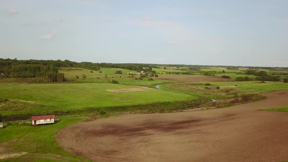 Aerial View of Fields Meadows Forests and Winding River alt