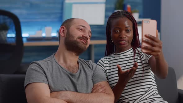 Young Interracial Couple Using Online Video Call Conference alt