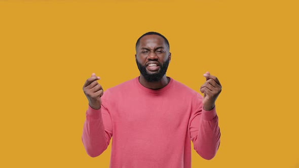 Black Man Doing Rich Hand Gesture, Pay Money Sign. on Yellow Background alt