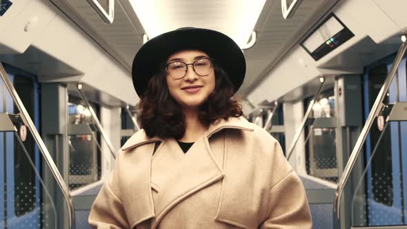 Closeup of a Girl in a Hat in an Empty Subway Car alt