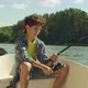 Cute Arab Teenage Boy with Spin Fishing Rod Fishing From Boat on Lake, Stock  Footage