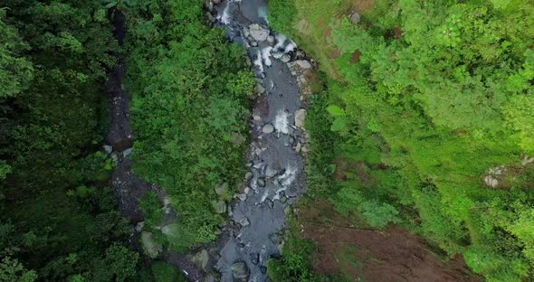 aerial view of the river leading to kedung kayang waterfall in central java indonesia wide drone sho alt