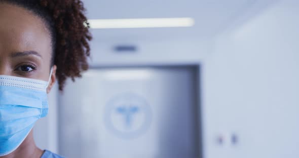 Portrait of mixed race female doctor wearing face mask alt