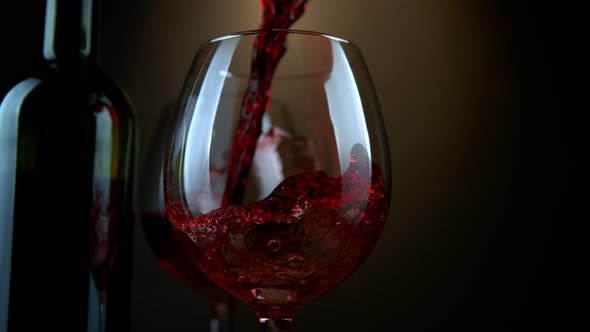 Super Slow Motion Shot of Pouring Red Wine From Bottle with Camera Rotation at 1000Fps alt