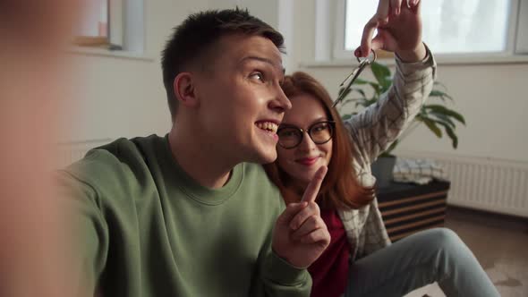 The Man Takes Off Himself and His Girlfriend on the Phone in a New Apartment alt