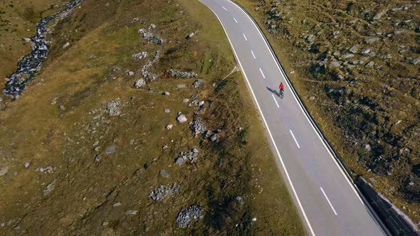 Road Cyclist Climbs Up Sunset Mountain Switchbacks
