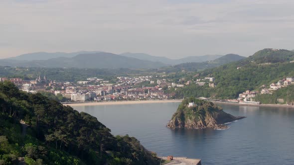 Beautiful hilly landscape and city of San Sebastian, aerial drone view alt
