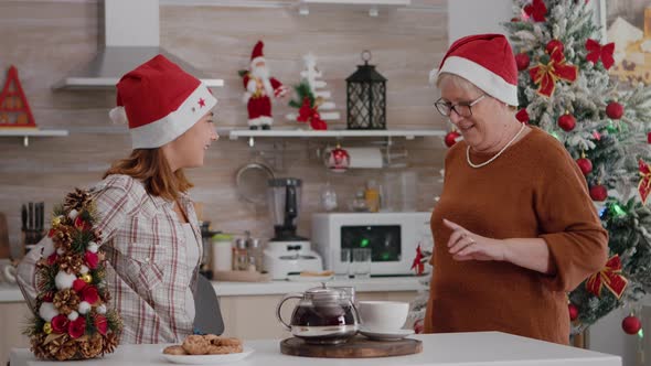 Happy Family Wearing Santa Hat Surprising Each Other with Wrapper Xmas Present Gift alt