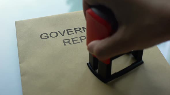 Government Report Classified Stamping Seal on Folder With Important Documents alt
