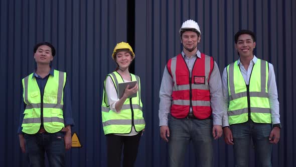 Cheerful factory worker and engineer at cargo containers, Dock workers team in a shipyard
