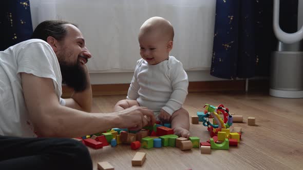 Happy Baby In Playing Room With Dad