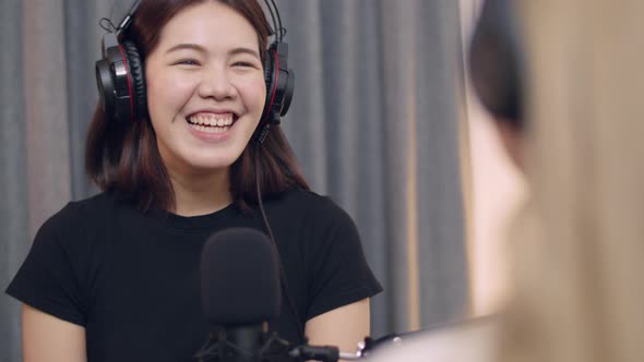 Two Young Asian women journalists and influencers' conversations discussion recording podcast.