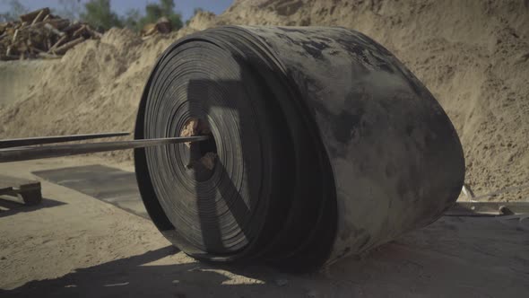 Loader Raising Black Rubber Conbeyor Belt for Bulk Materials Outdoors. Heavy Industrial Machinery alt