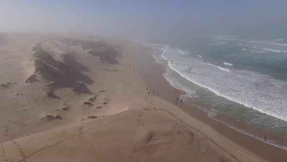 Drone Flying Along Coastline with Fog Billow in Background