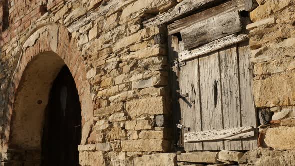 Weathered  stone building facade details  4K 2160p 30fps UltraHD footage - Ancient wine cellar woode