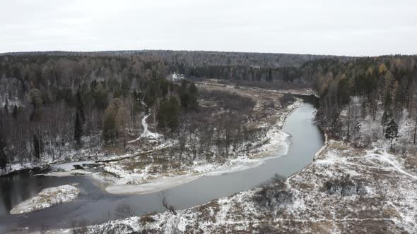 A Cold Winter River Flows Through the Forest
