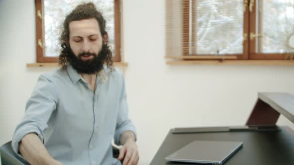 After Finishing the Office Work or Video Call the Man Takes the Tool and Starts Playing It alt