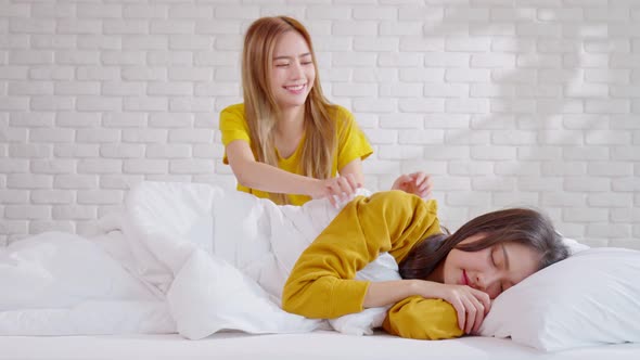 LGBT lesbian awake embracing and looking together with love and romance on bed.Positive mood and mom alt
