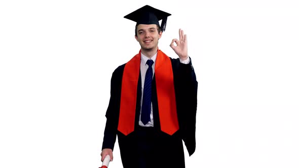 Smiling Graduating Student In Black Gown Showing Ok Sign