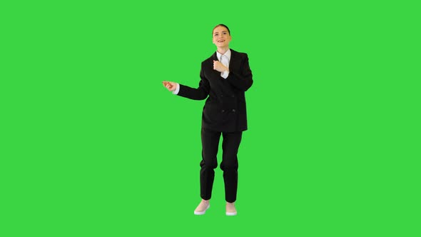 Young Woman in Office Suit Dances Waving Her Arms on a Green Screen Chroma Key