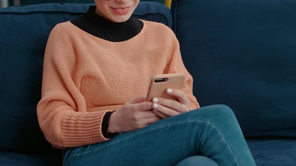 Woman Using Smartphone to Browse Internet and Learn Online Lesson alt