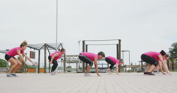 Female friends enjoying exercising at boot camp together alt