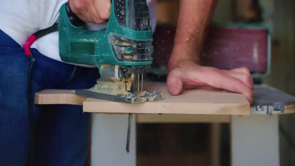 Handmade Furniture Production and Making Wooden Goods Master is Sawing Wood Board alt