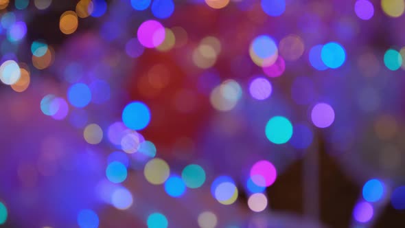 Shimmering abstract colored circles defocused christmas lights video. Blurred fairy lights.  alt