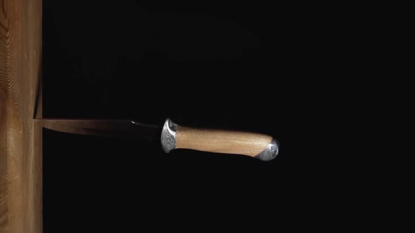 Sharp Hunting Knife Stuck In A Wooden Wall alt
