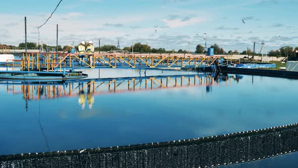 Wastewater Operators Inspecting a Circular Clarifier in Daylight alt