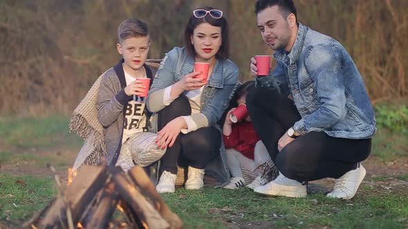 Happy Four Member Family of Mother Father and Two Boy Kids Hugging Enjoying Togetherness Outdoors in alt